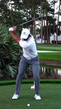 Tiger Woods at mid-downswing — lead hip stacking over lead ankle