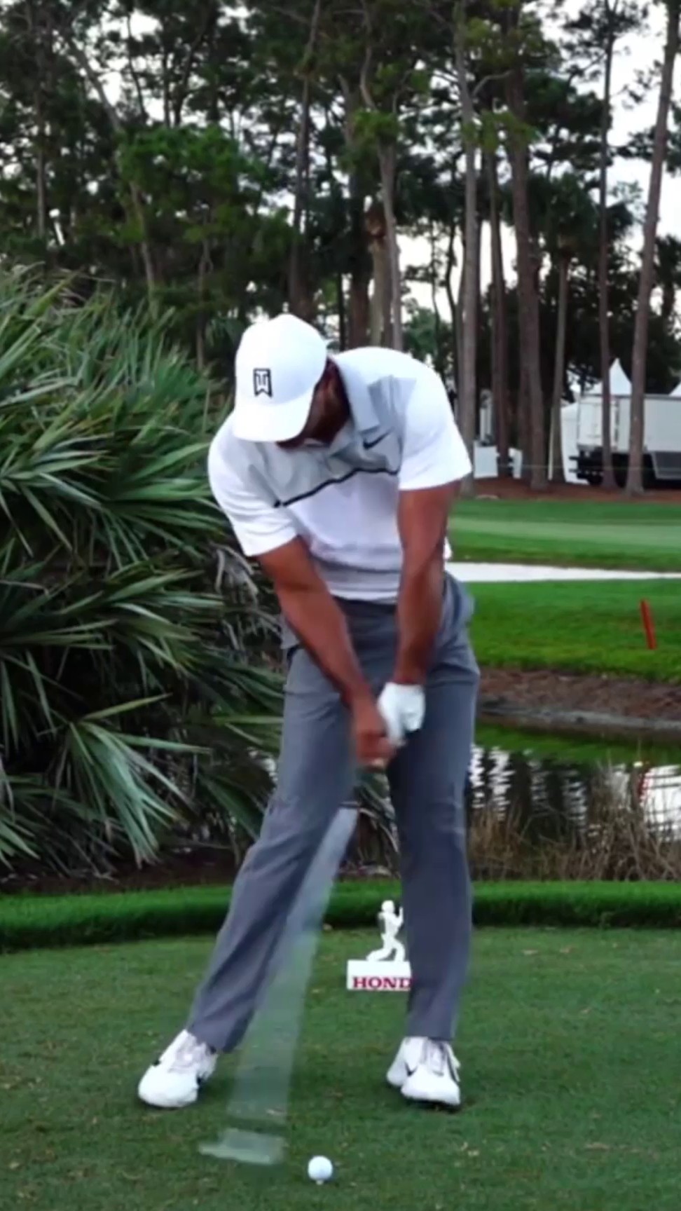 Tiger Woods at impact — pelvis up, heavy trail-side bend